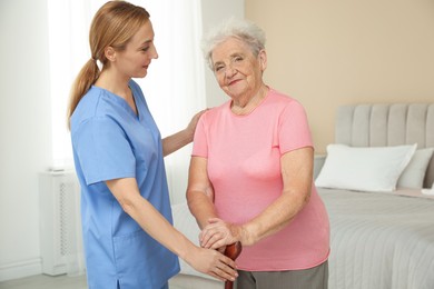 Healthcare worker supporting senior patient at home