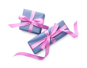 Photo of Beautiful gift boxes with pink bows isolated on white, top view