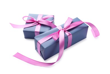 Photo of Beautiful gift boxes with pink bows isolated on white