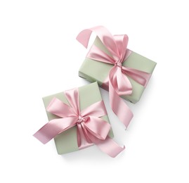 Photo of Beautiful gift boxes with pink bows isolated on white, top view