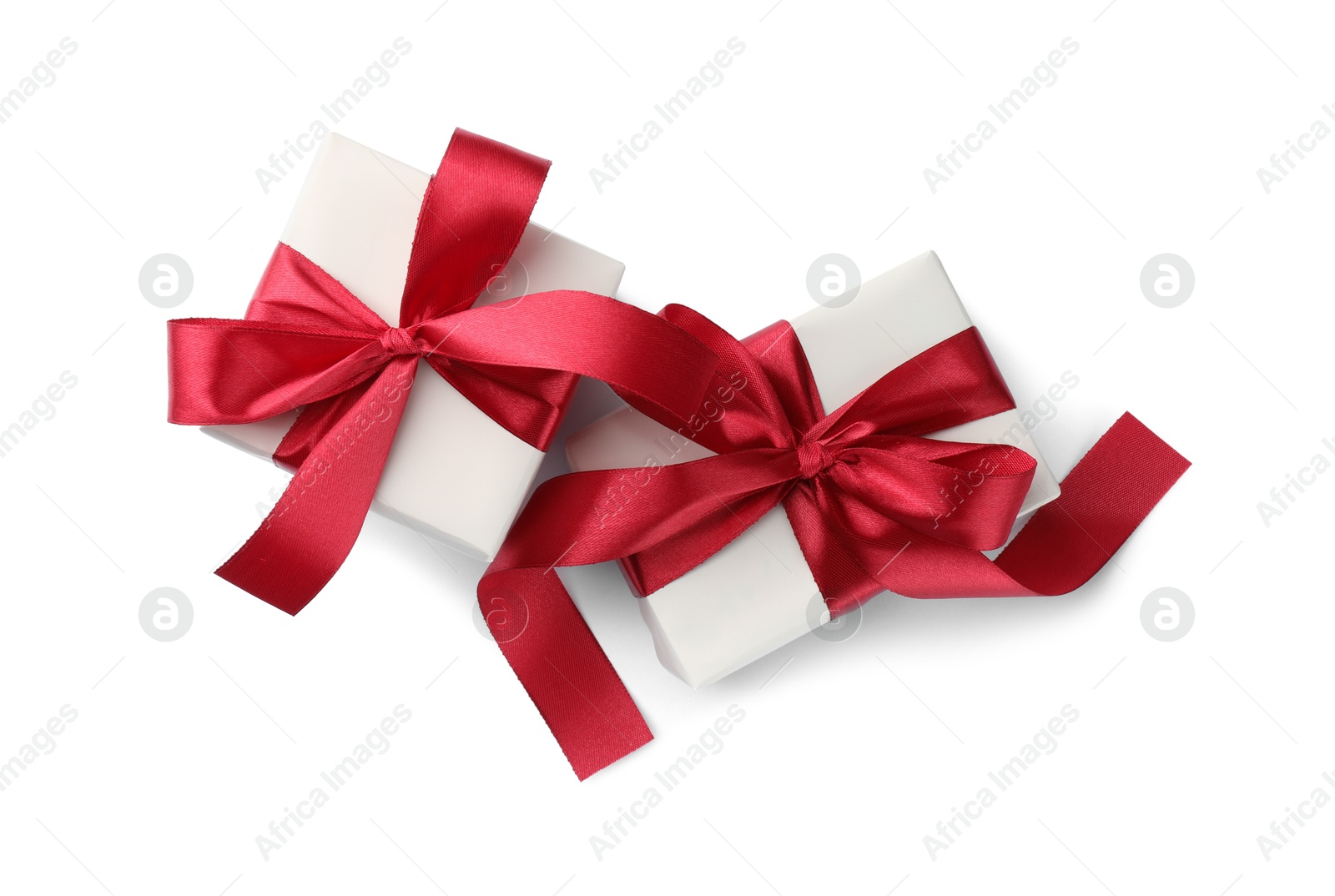 Photo of Beautiful gift boxes with red bows isolated on white, top view