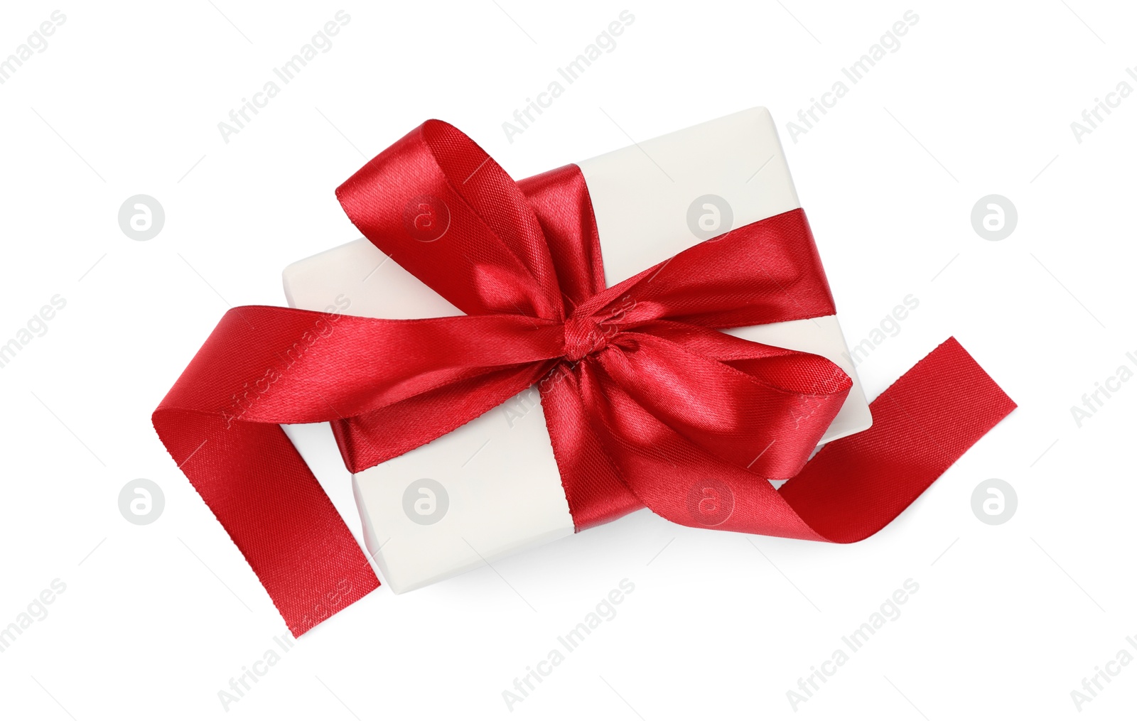 Photo of Beautiful gift box with red bow isolated on white, top view