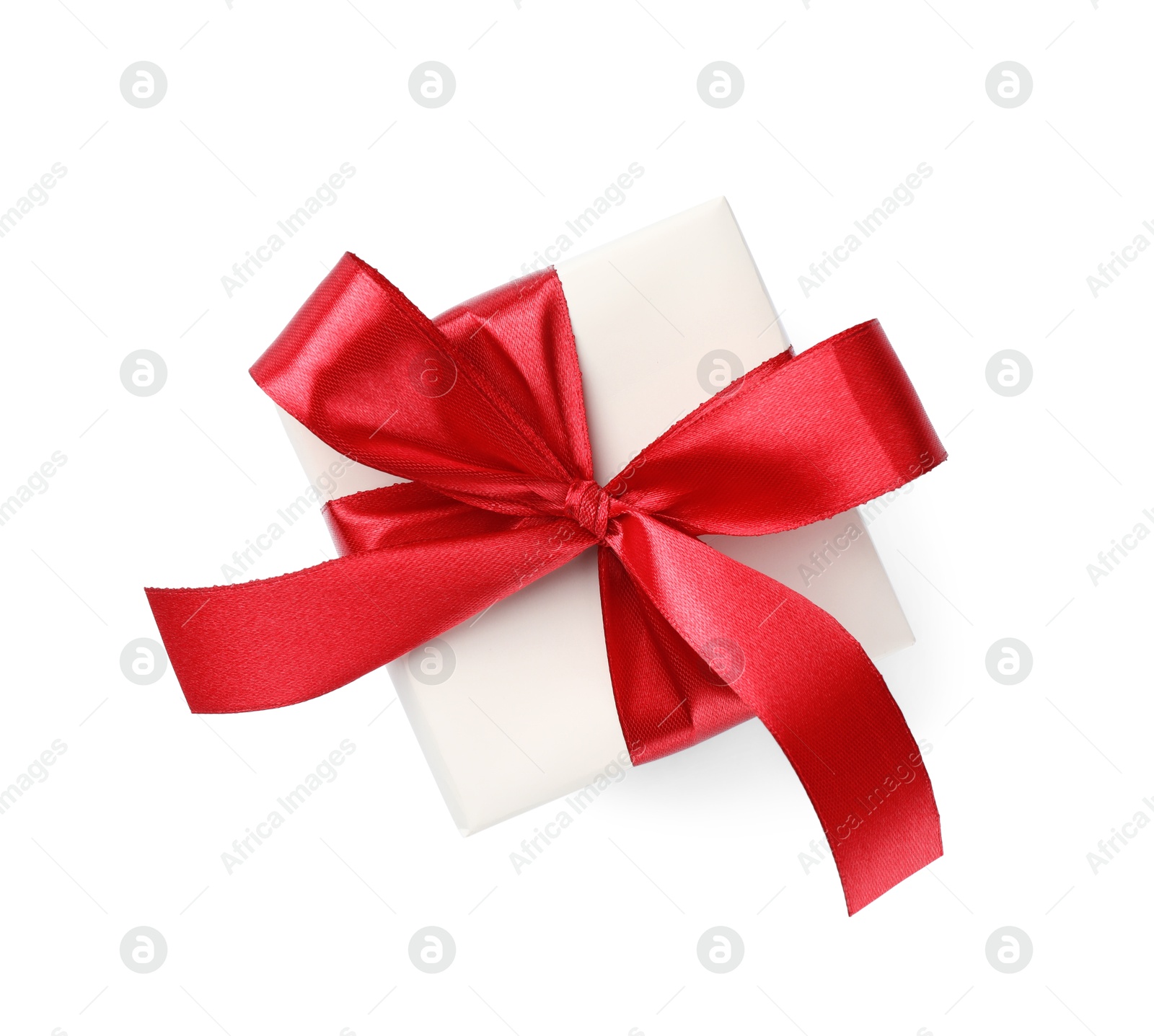 Photo of Beautiful gift box with red bow isolated on white, top view