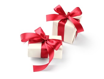 Photo of Beautiful gift boxes with red bows isolated on white