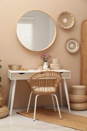 Photo of Stylish dressing table with mirror in room