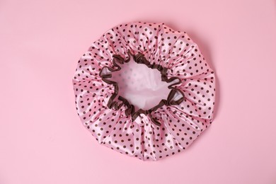 Photo of One shower cap on pink background, top view