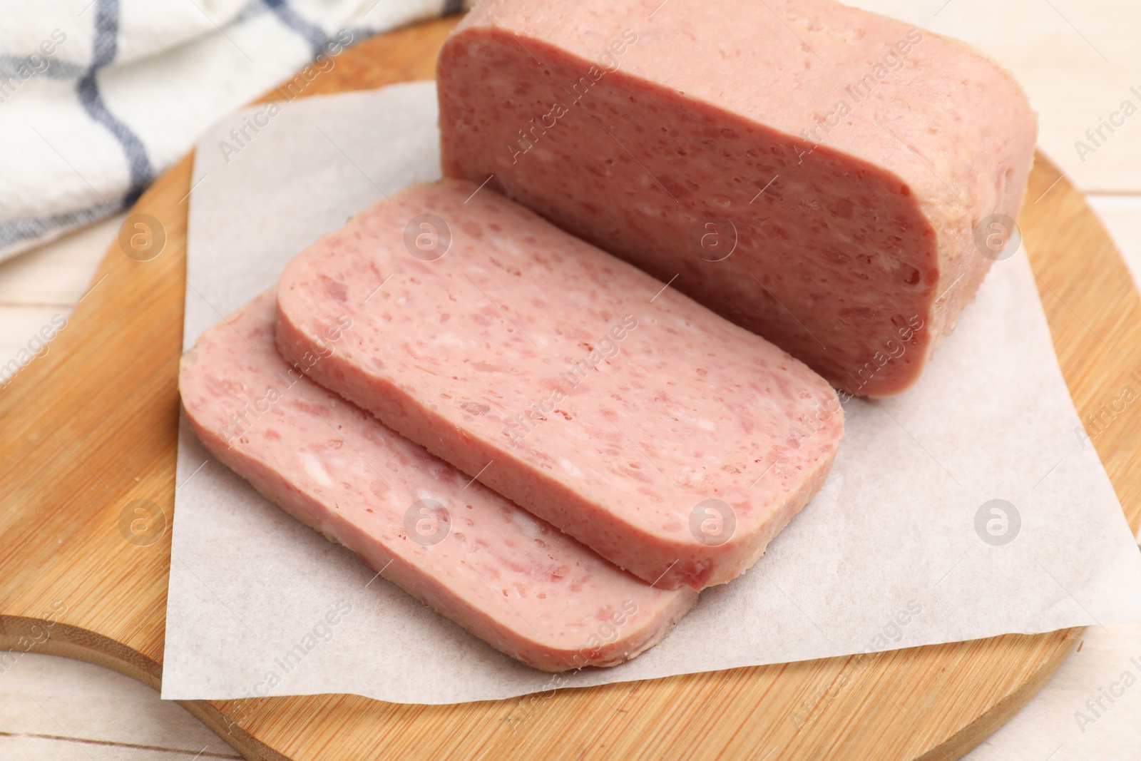 Photo of Tasty canned meat on light table, closeup