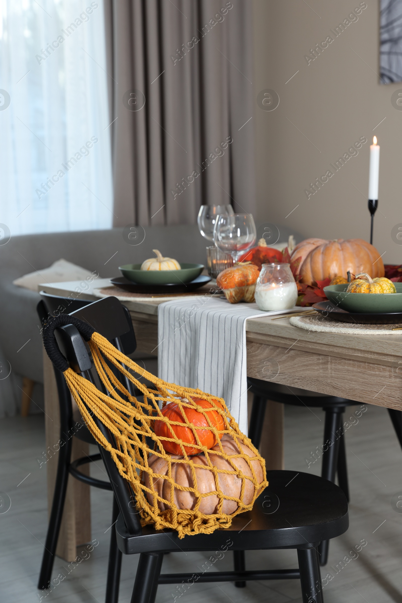 Photo of Macrame bag with products on chair indoors