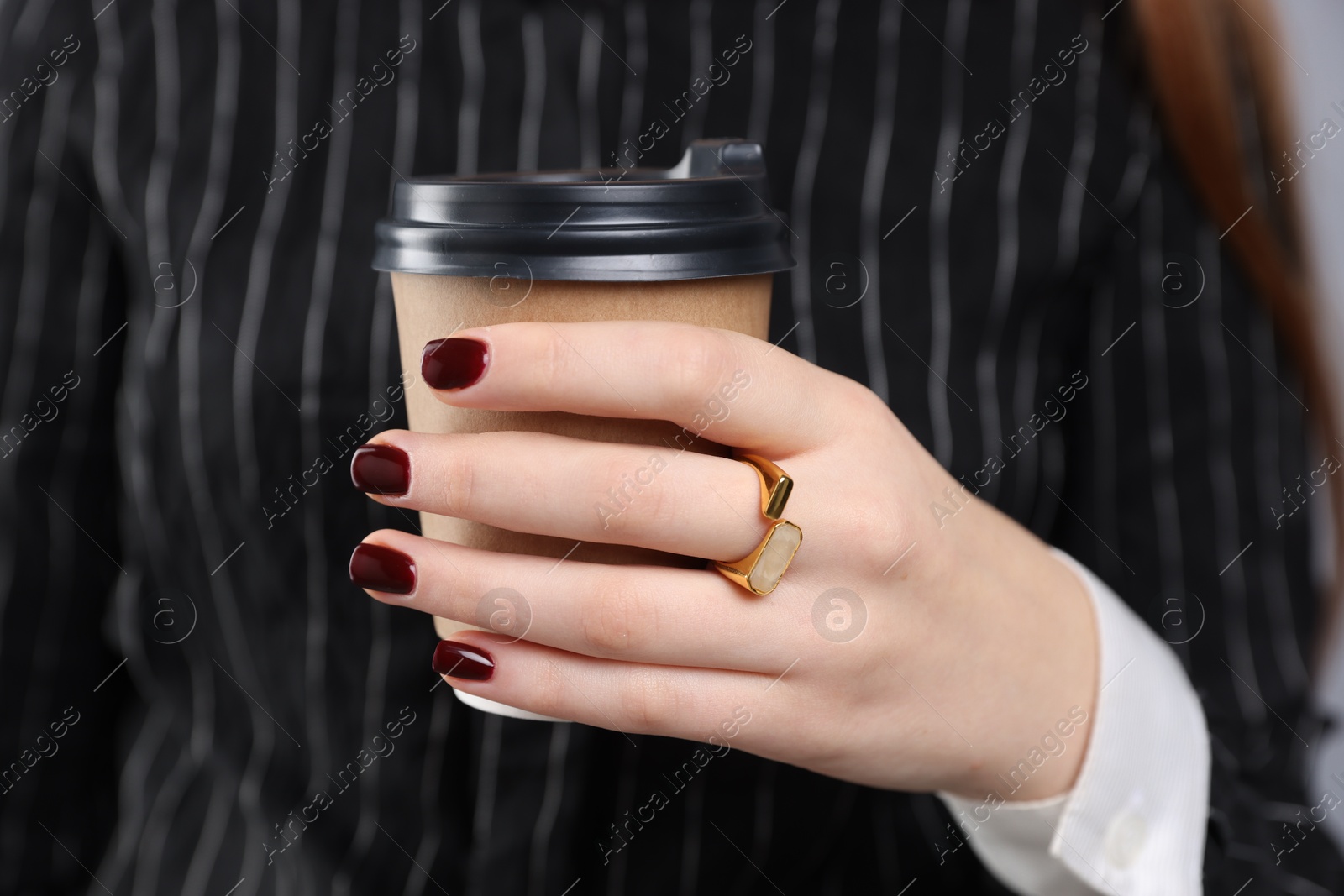 Photo of Teenage girl with stylish ring and paper cup of coffee, closeup