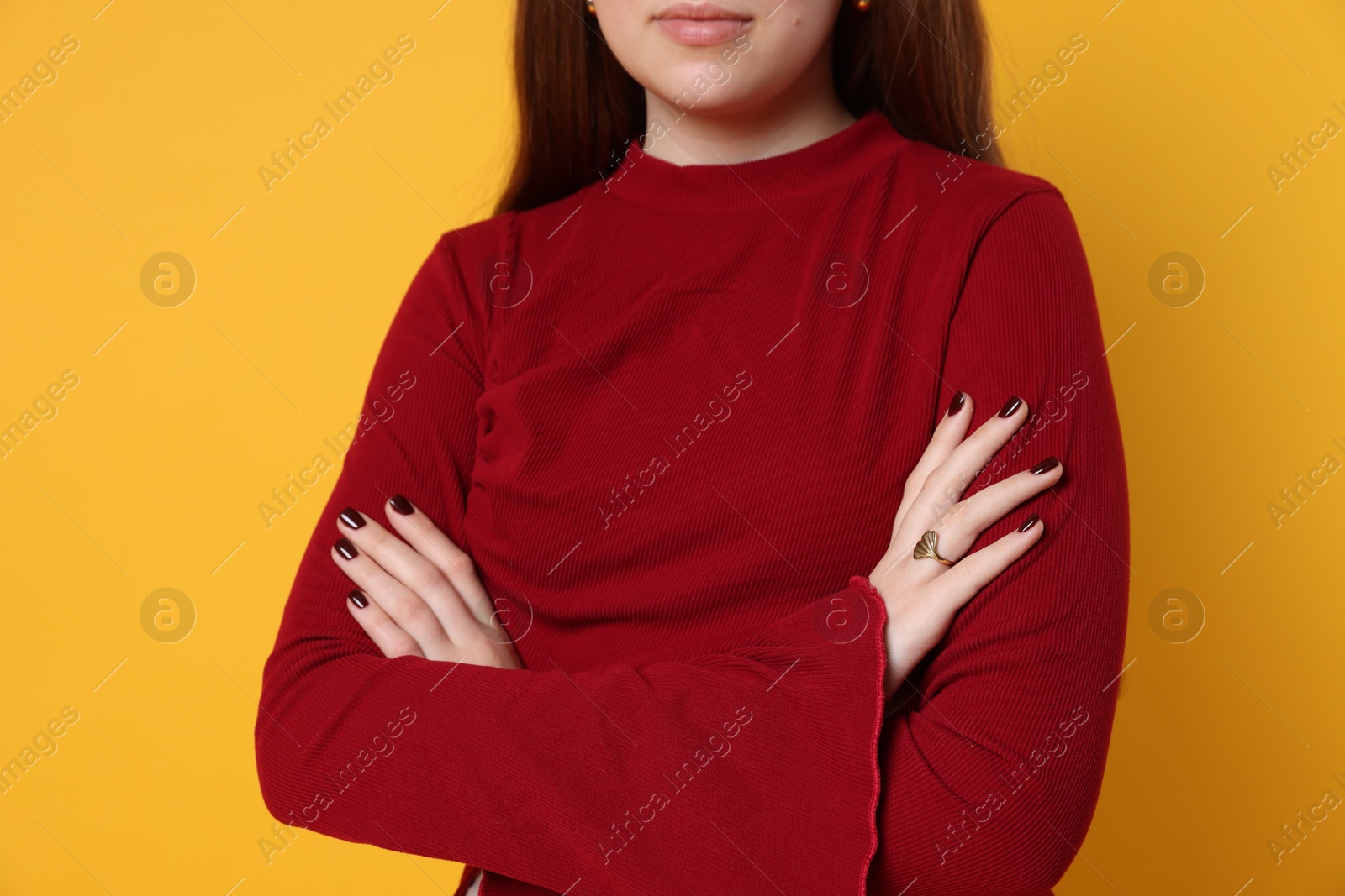 Photo of Teenage girl wearing stylish jewellery on yellow background, closeup