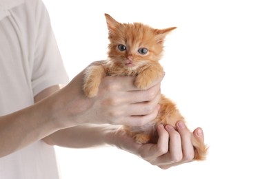 Photo of Teenage boy holding cute ginger kitten on white background, closeup