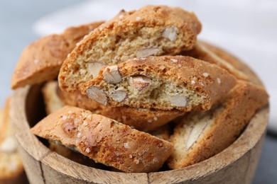 Photo of Traditional Italian almond biscuits (Cantucci) in bowl on table, closeup