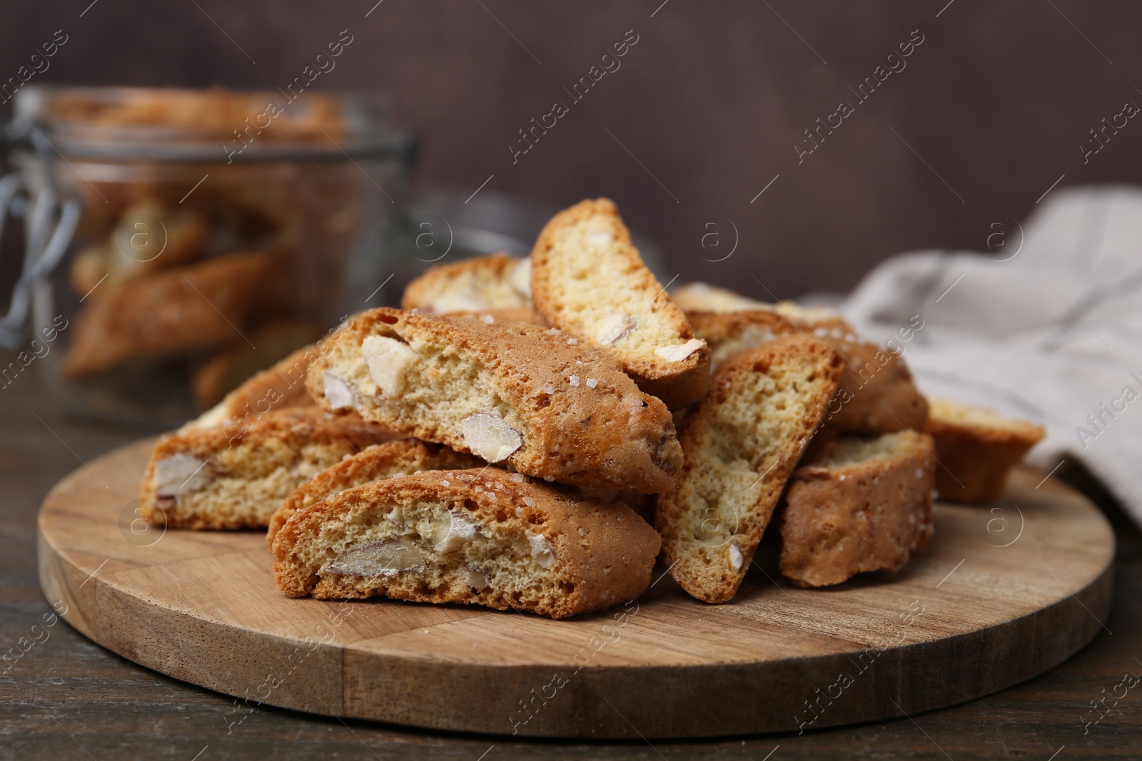 Photo of Traditional Italian almond biscuits (Cantucci) on wooden table, closeup