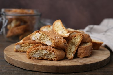 Photo of Traditional Italian almond biscuits (Cantucci) on wooden table, closeup