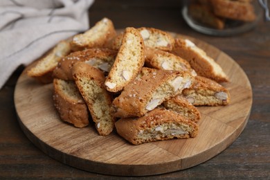 Photo of Traditional Italian almond biscuits (Cantucci) on wooden table, closeup