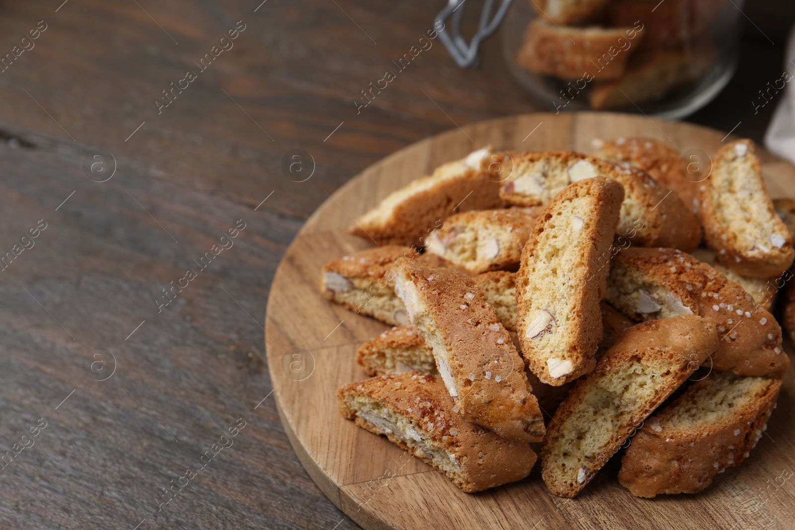 Photo of Traditional Italian almond biscuits (Cantucci) on wooden table, closeup. Space for text