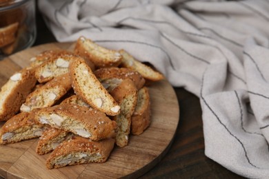 Photo of Traditional Italian almond biscuits (Cantucci) on wooden table, closeup