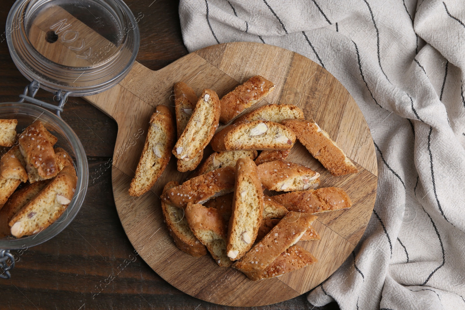 Photo of Traditional Italian almond biscuits (Cantucci) on wooden table, flat lay