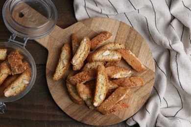 Photo of Traditional Italian almond biscuits (Cantucci) on wooden table, flat lay