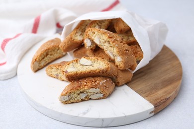 Photo of Traditional Italian almond biscuits (Cantucci) on light table, closeup