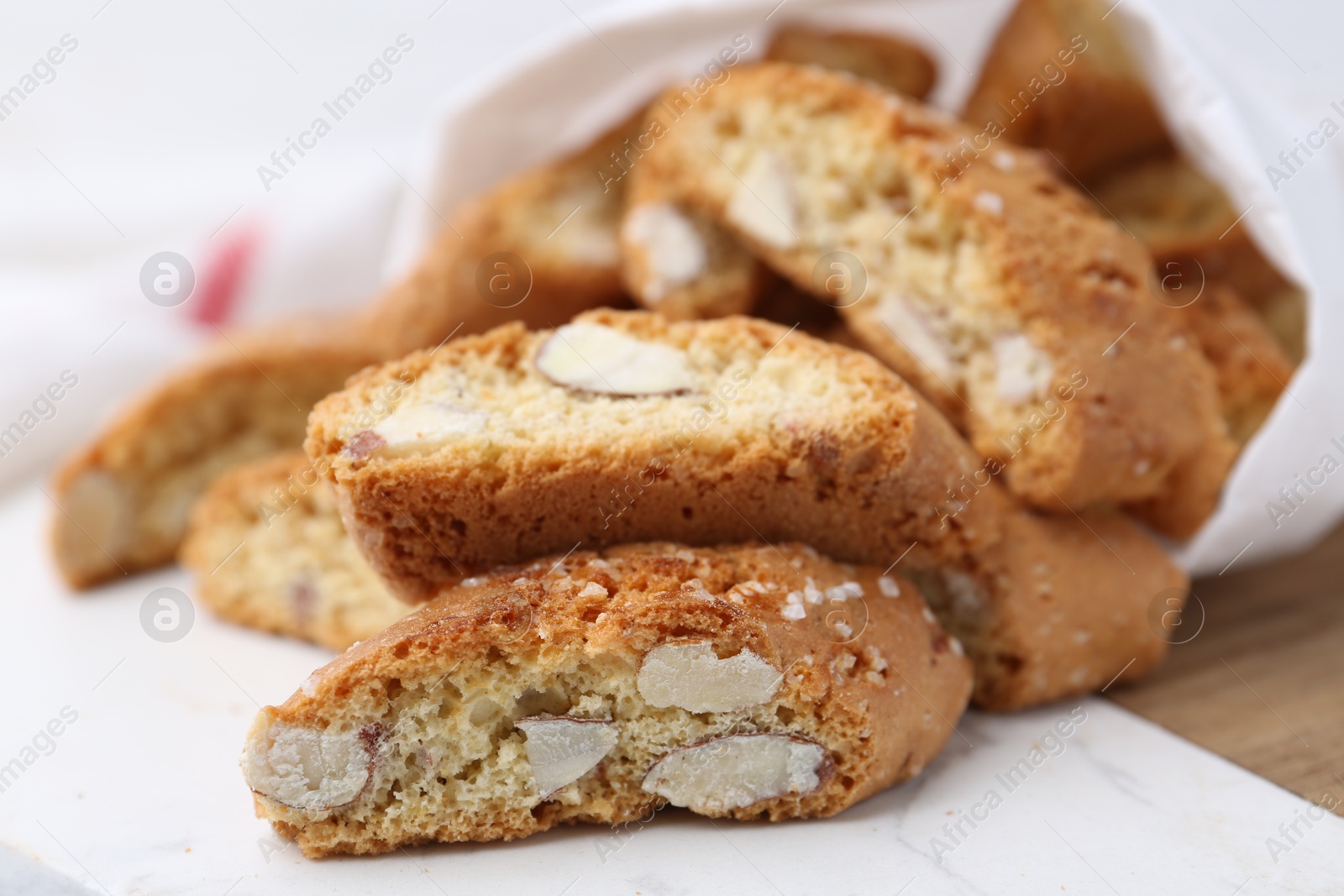 Photo of Traditional Italian almond biscuits (Cantucci) on board, closeup