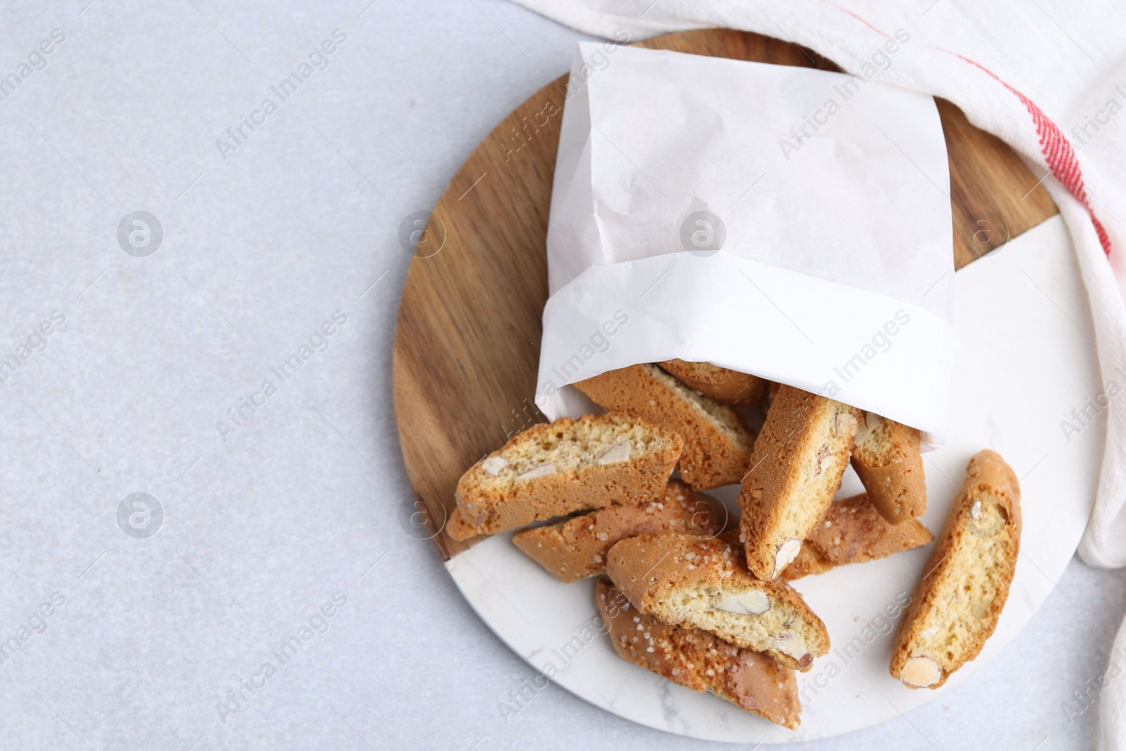 Photo of Traditional Italian almond biscuits (Cantucci) on light table, top view. Space for text