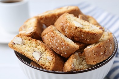 Photo of Traditional Italian almond biscuits (Cantucci) in bowl on table, closeup