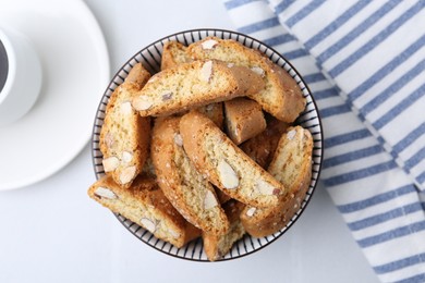 Photo of Traditional Italian almond biscuits (Cantucci) in bowl on white table, top view