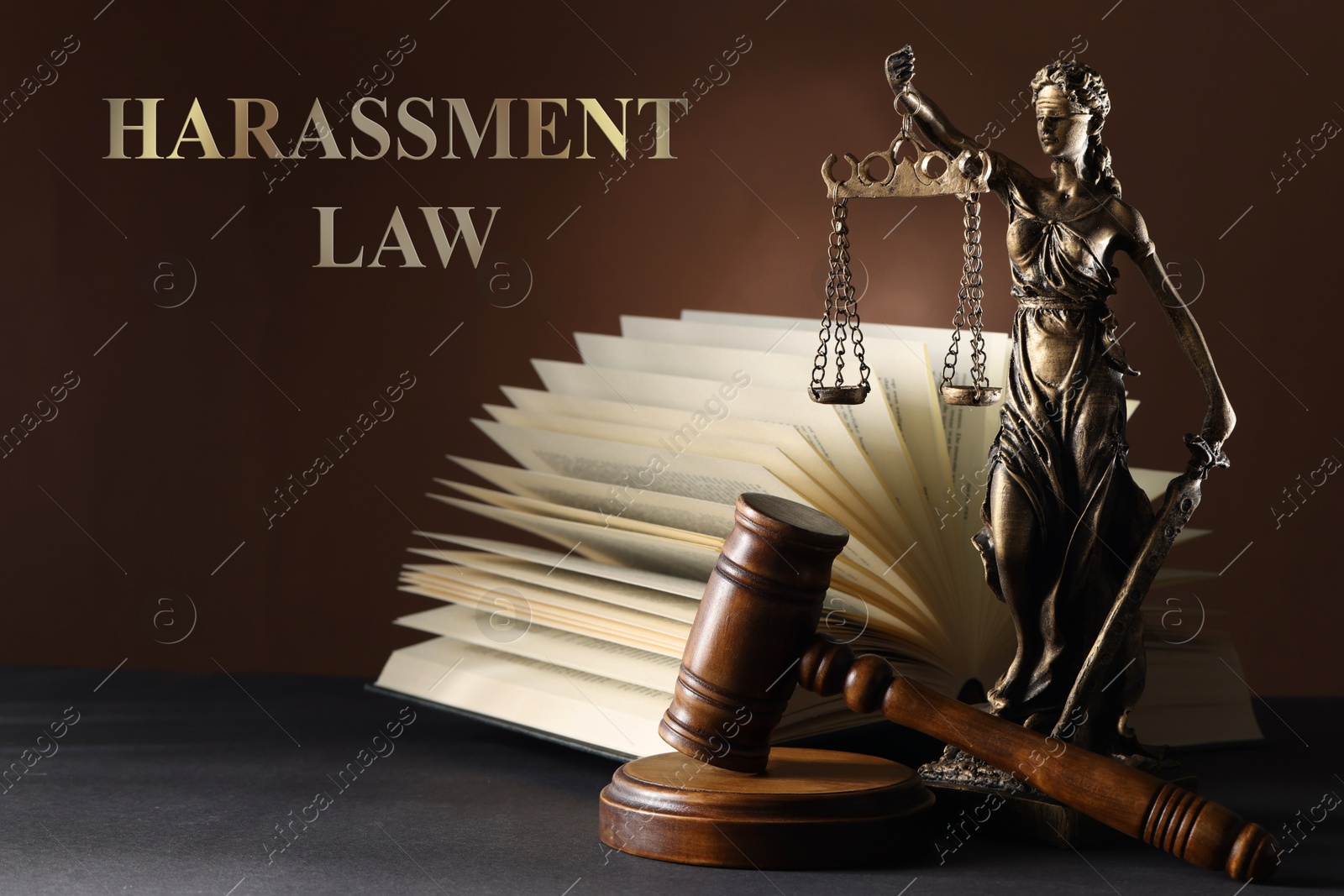 Image of Harassment law. Statue of Lady Justice near gavel and open book on grey table