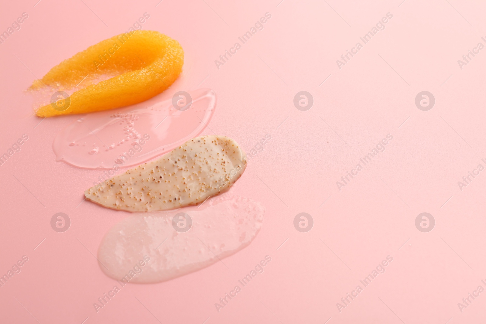 Photo of Samples of cosmetic products on pink background, space for text. Skin care