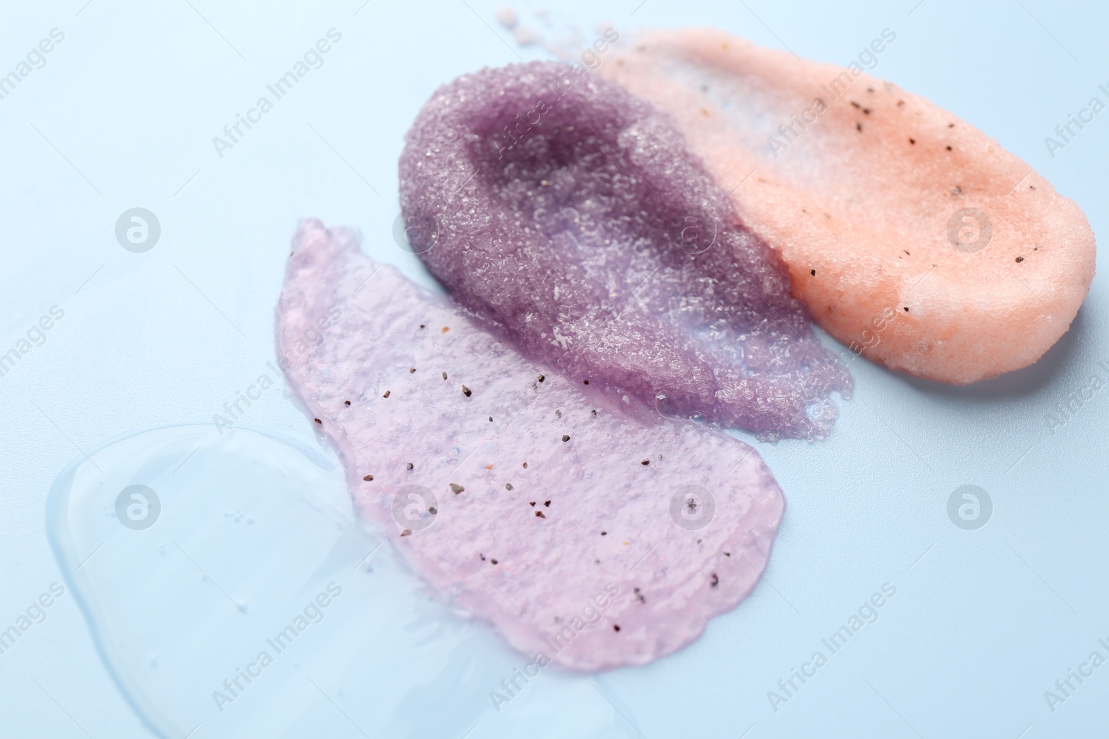 Photo of Samples of cosmetic products on light blue background, closeup. Skin care