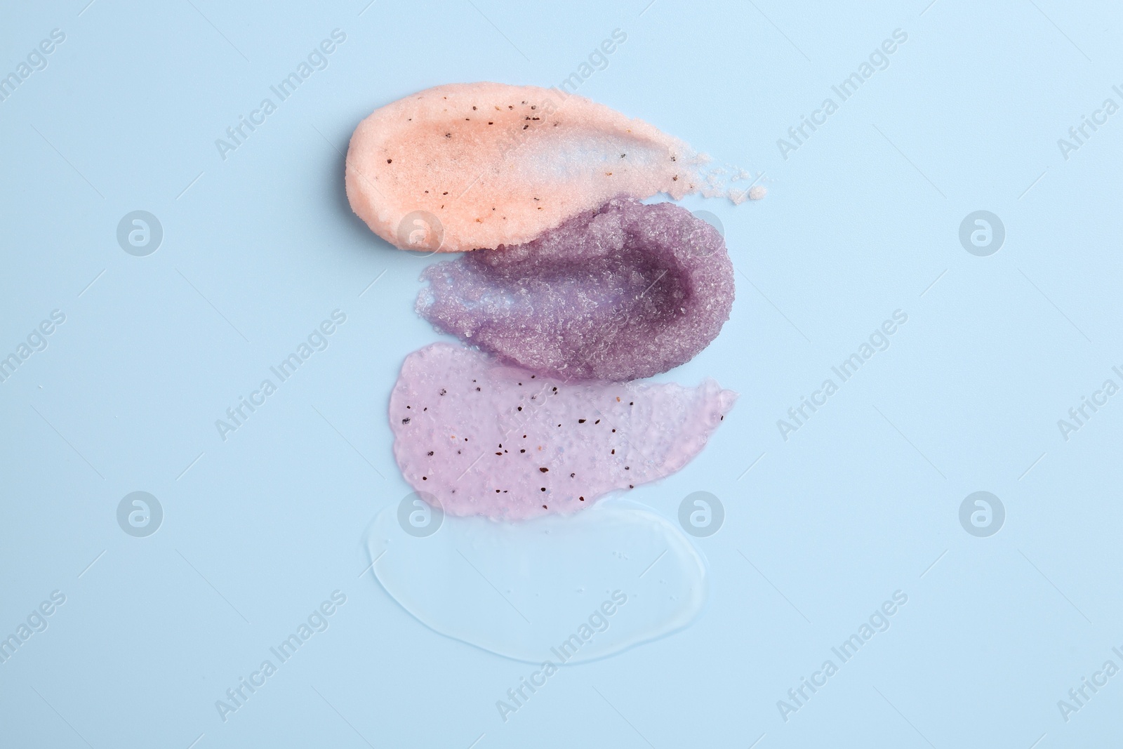 Photo of Samples of cosmetic products on light blue background, top view. Skin care