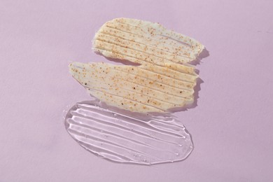 Photo of Samples of cosmetic products on light violet background, top view. Skin care