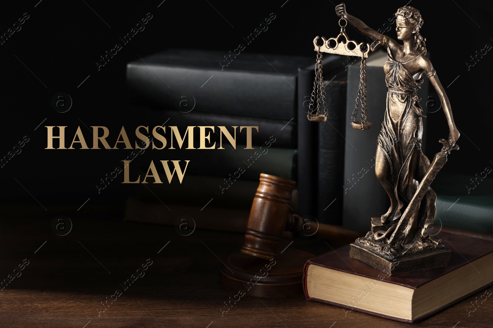 Image of Harassment law. Statue of Lady Justice near books and gavel on wooden table