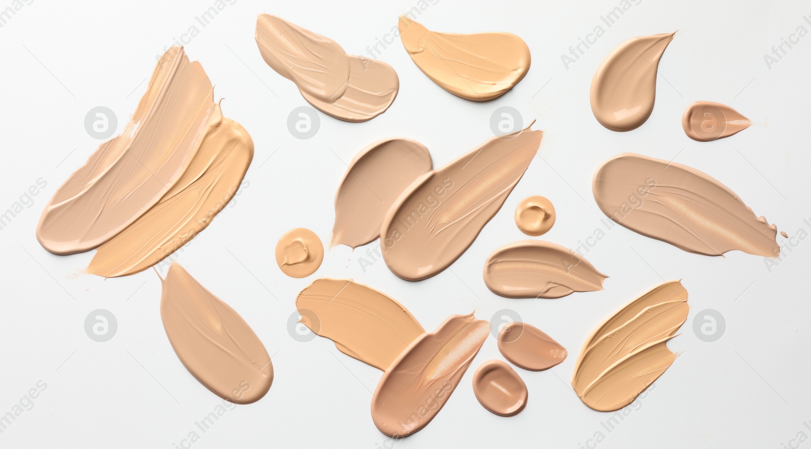 Photo of Samples of foundations on white background, top view