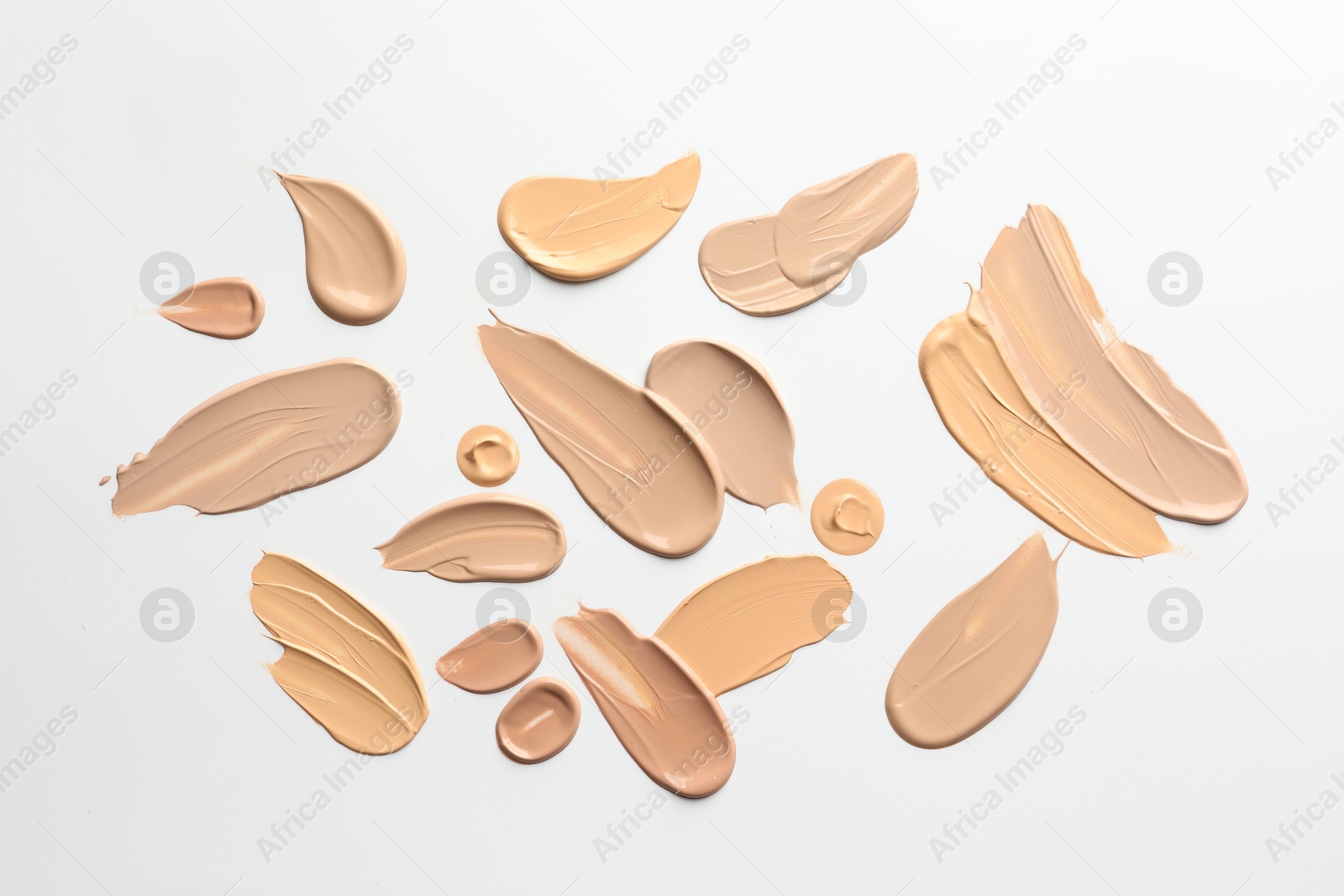 Photo of Samples of foundations on white background, top view