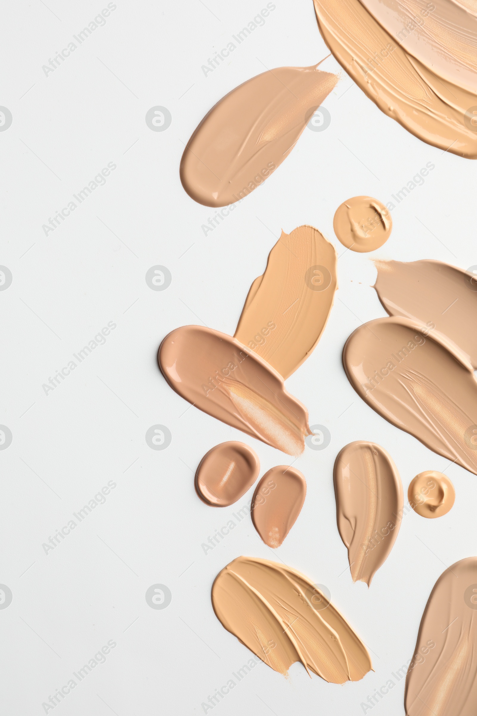 Photo of Samples of foundations on white background, top view