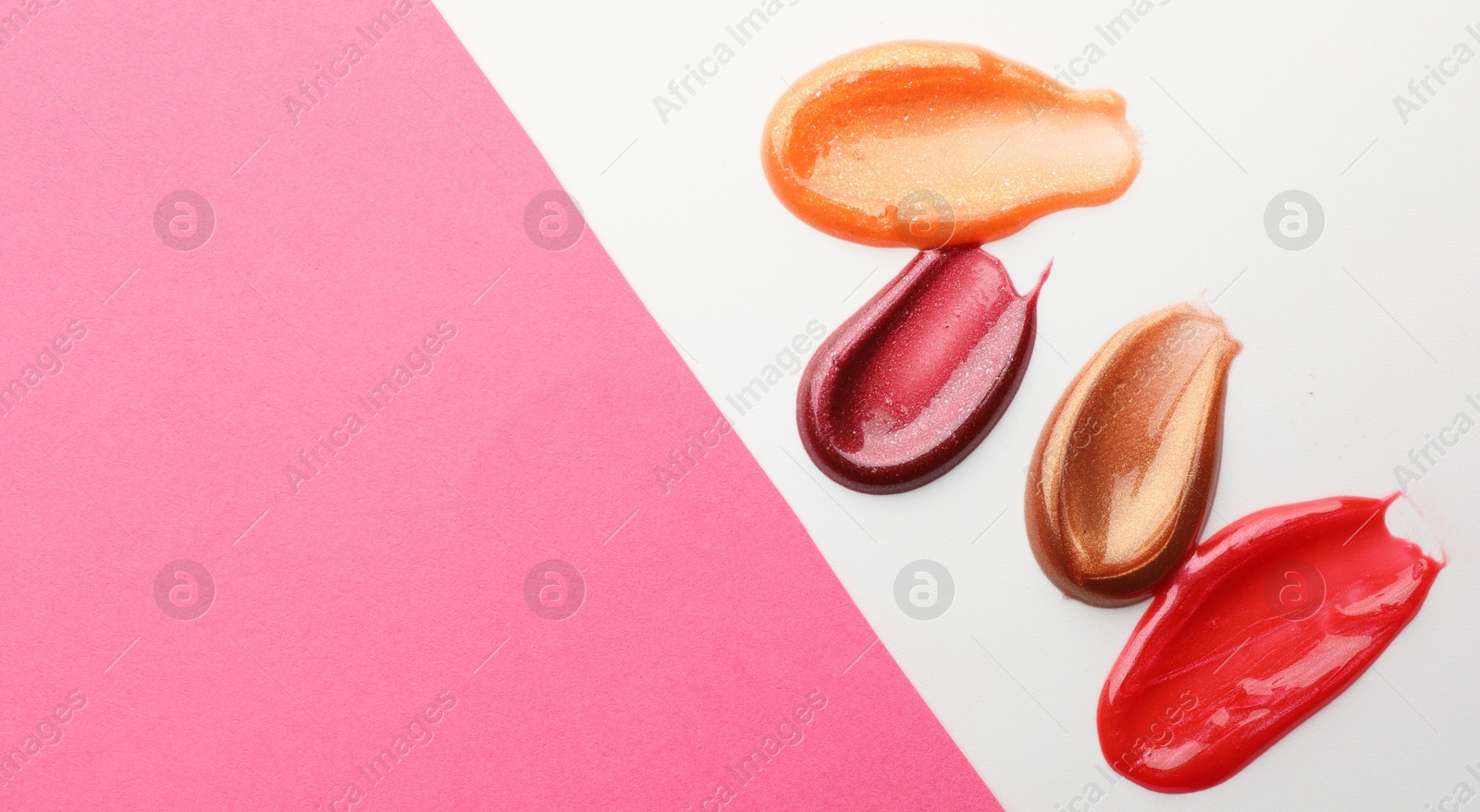 Photo of Smears of different lip products on color background, top view. Space for text