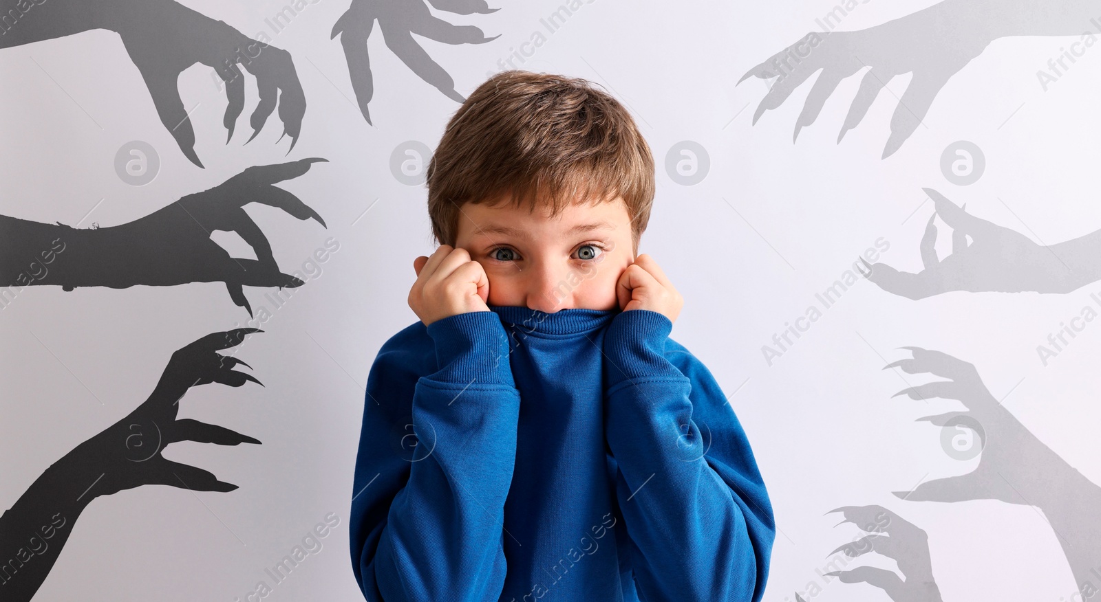 Image of Teraphobia - fear of monsters. Scared boy and silhouettes of creepy hands near him. Light background