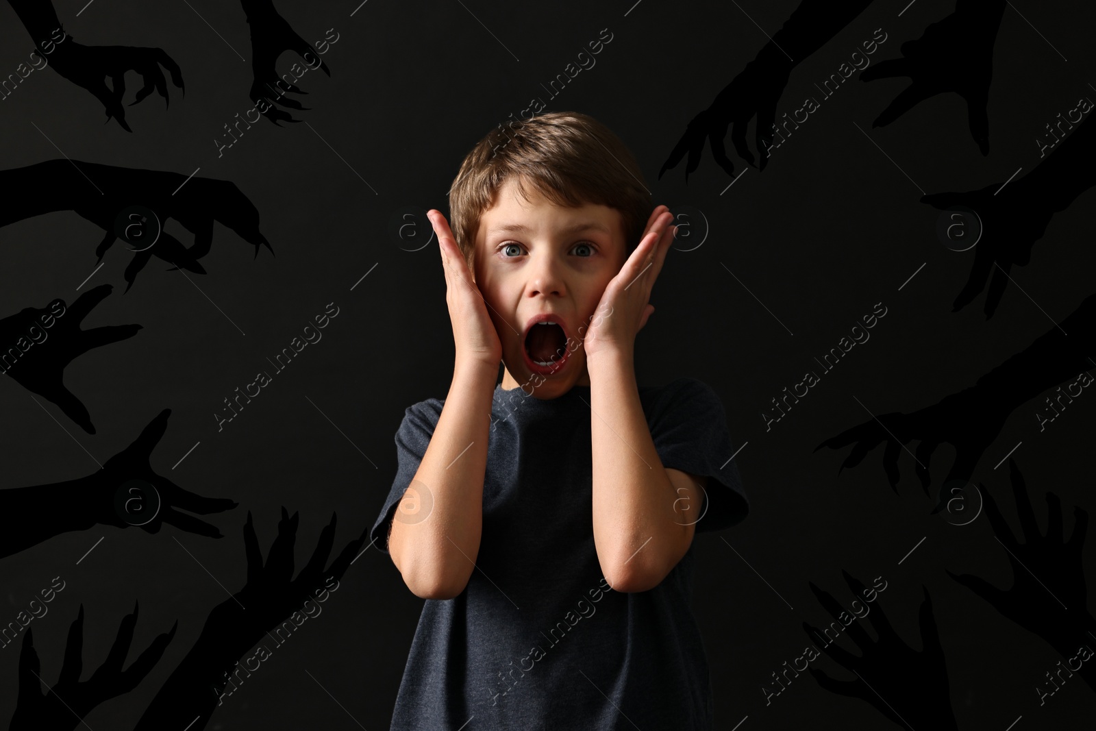 Image of Teraphobia - fear of monsters. Scared boy screaming on black background. Silhouettes of creepy hands near him