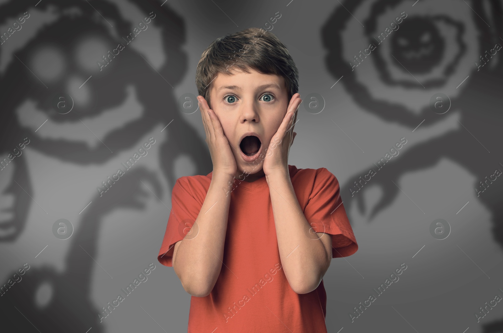 Illustration of Boy scared of monsters, teraphobia. Creepy shadows behind him