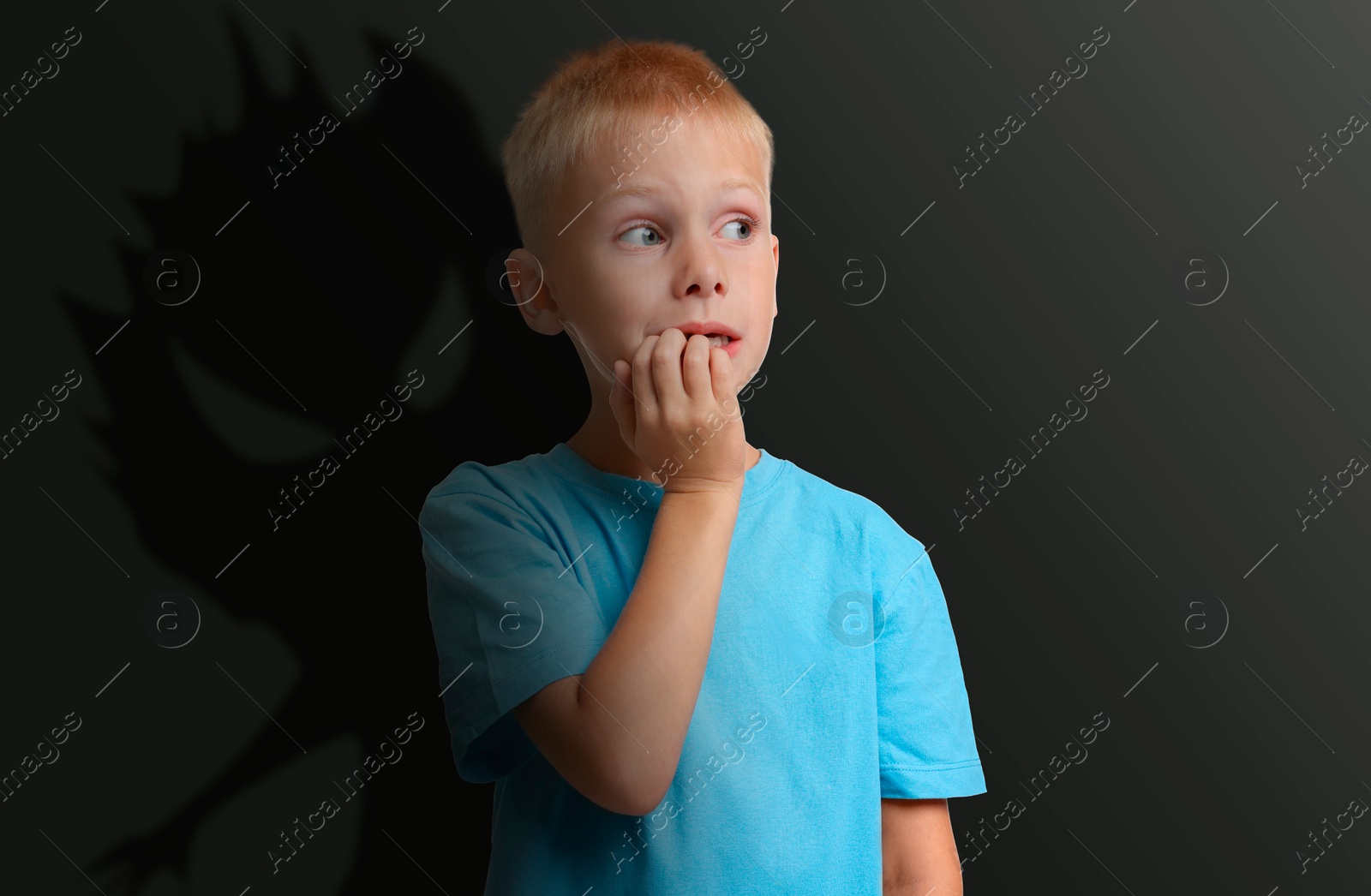 Illustration of Boy scared of monsters, teraphobia. Creepy shadow behind him