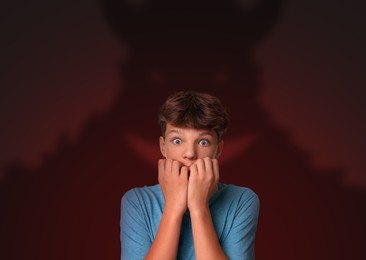 Illustration of Boy scared of monsters, teraphobia. Creepy shadow behind him