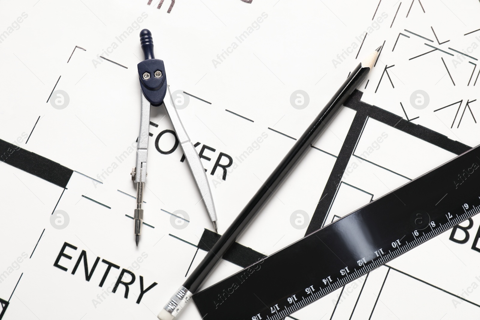 Photo of Ruler, pencil and dividers on different architectural drawings, top view