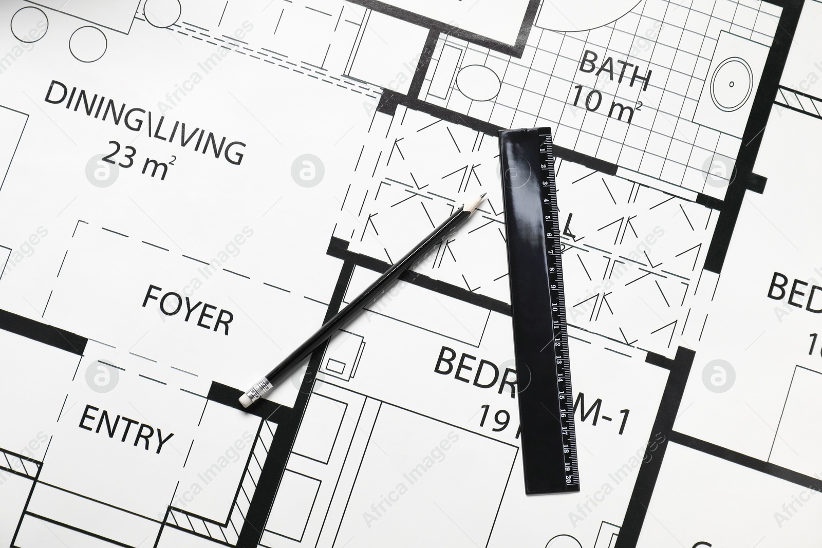 Photo of Ruler and pencil on different architectural drawings, top view