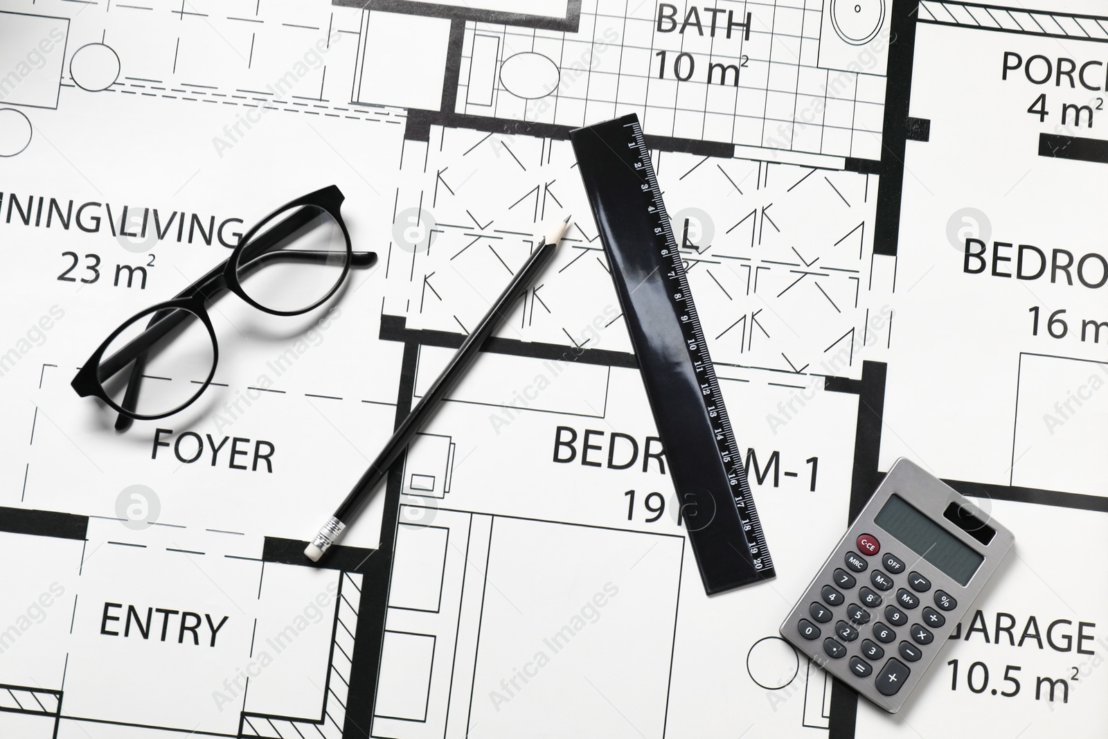 Photo of Ruler, glasses, calculator and pencil on different architectural drawings, top view