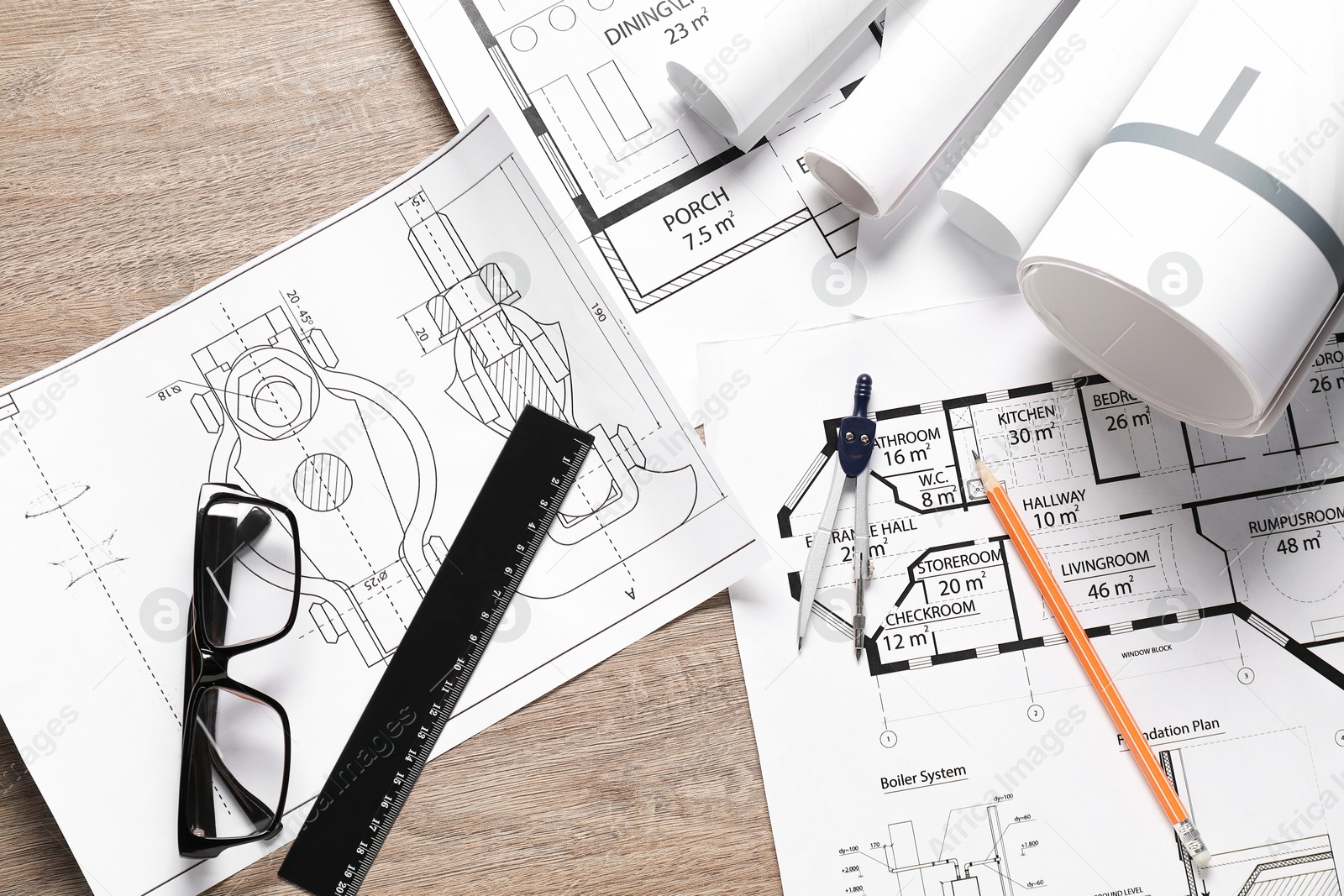 Photo of Different engineering drawings, glasses, ruler, pencil and dividers on wooden table