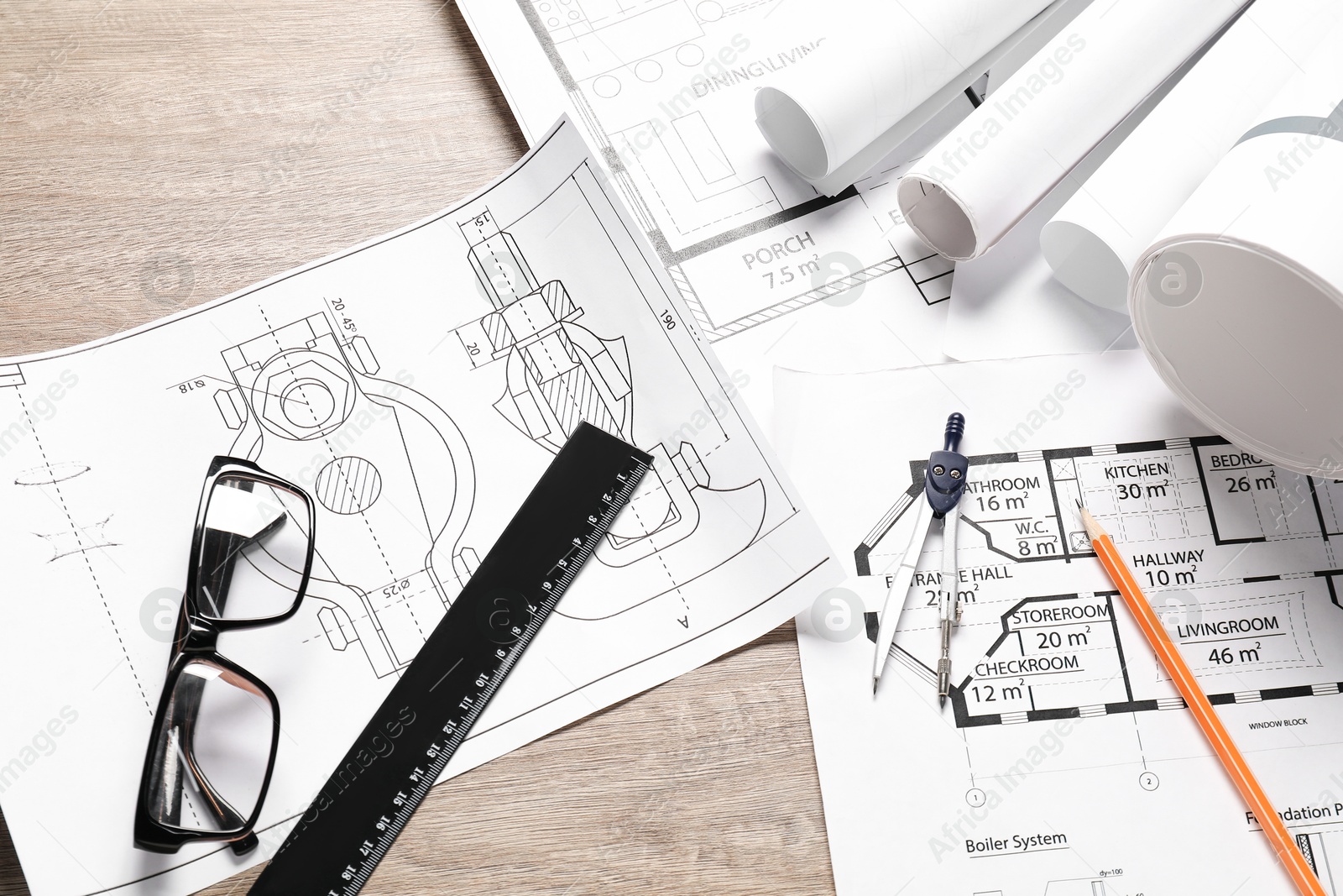 Photo of Different engineering drawings, glasses, ruler, pencil and dividers on wooden table