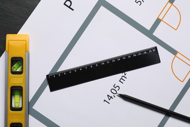 Architectural drawing, building level, ruler and pencil on grey table, flat lay