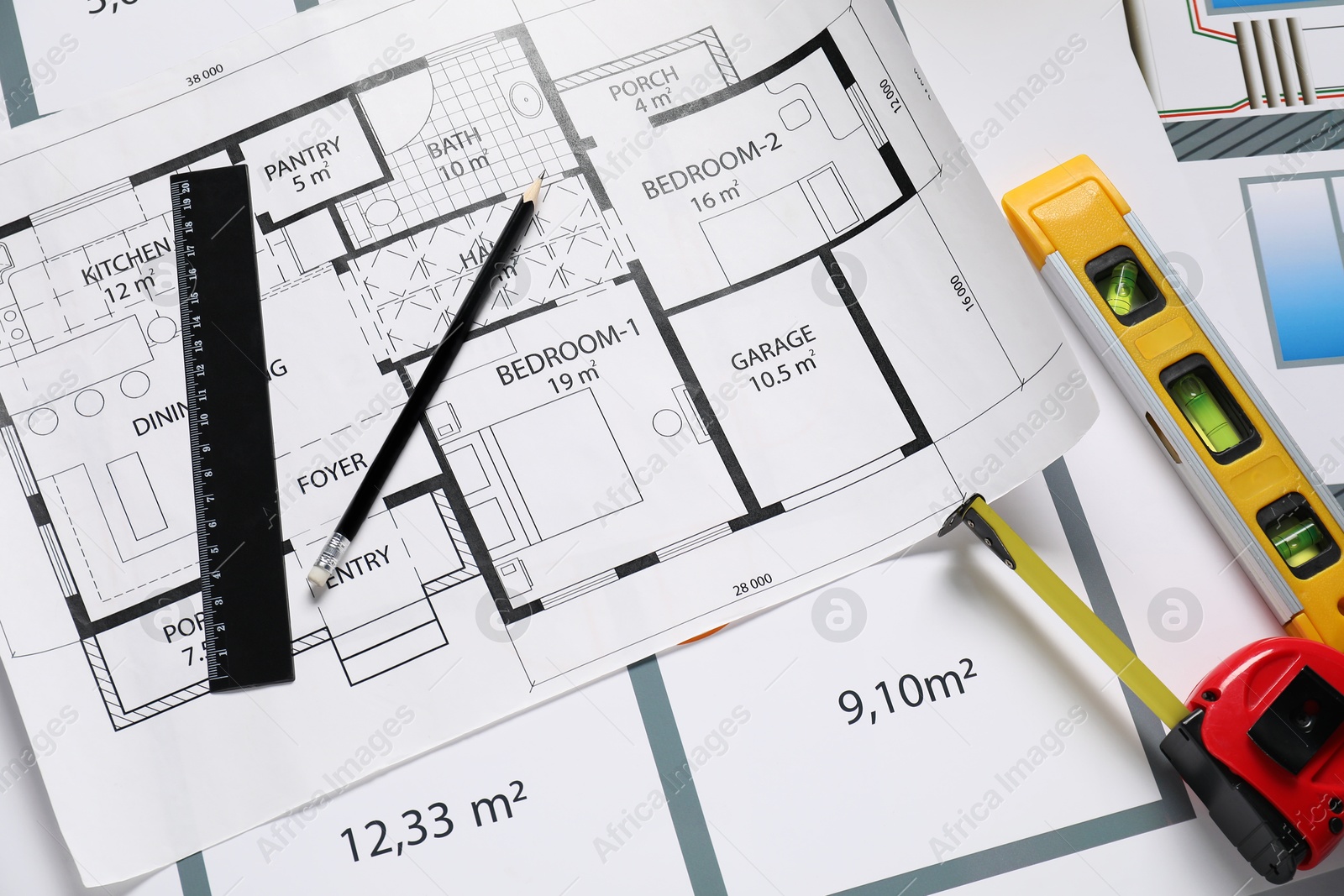 Photo of Different tools on architectural drawings, flat lay